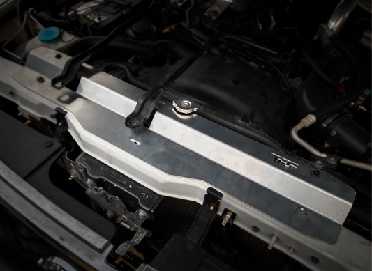 GU Patrol - silver aluminum radiator cover installed on a vehicle's engine bay.
